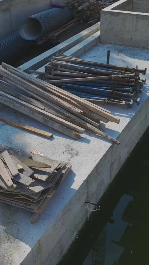 Vertical Video: Teams Building Walls Using Concrete, Metal, and Tools While Stock Footage 342908386