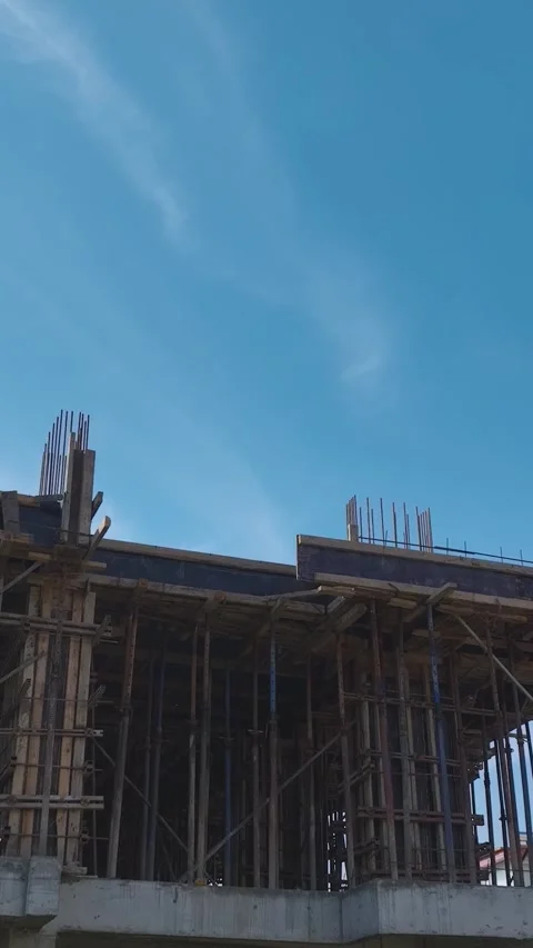 Vertical Video: Teams Using Tools, Metal, and Concrete Mixers to Build Stock Footage 342908718