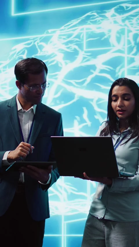 Vertical video Teamworking colleagues using AI neural networks modeled after Stock Footage 278552184