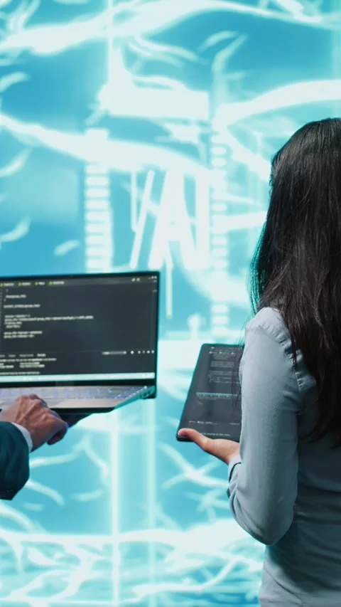 Vertical video Teamworking IT staff members using AI system aiding in processing Stock Footage 278553556