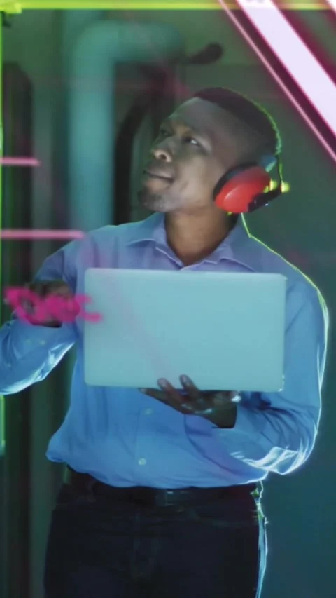Vertical video: tech checking laptop in data aisle causing pink charts filling Stock Footage 330332820