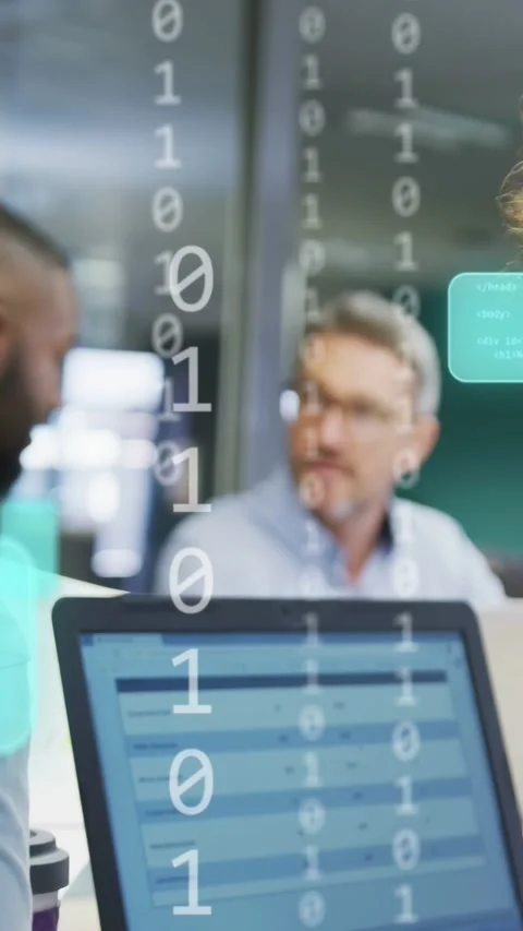 Vertical video: Tech coworker pointing laptop causing binary overlay while team Stock Footage 334024845