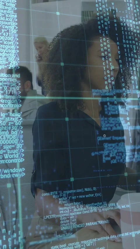 Vertical video: Tech dev typing at desk, pullback revealing code overlay Video stock 334317424