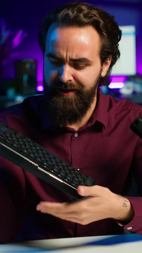 Vertical video Tech expert testing headphones, mouse and keyboard, reviewing Stock Footage 311008553