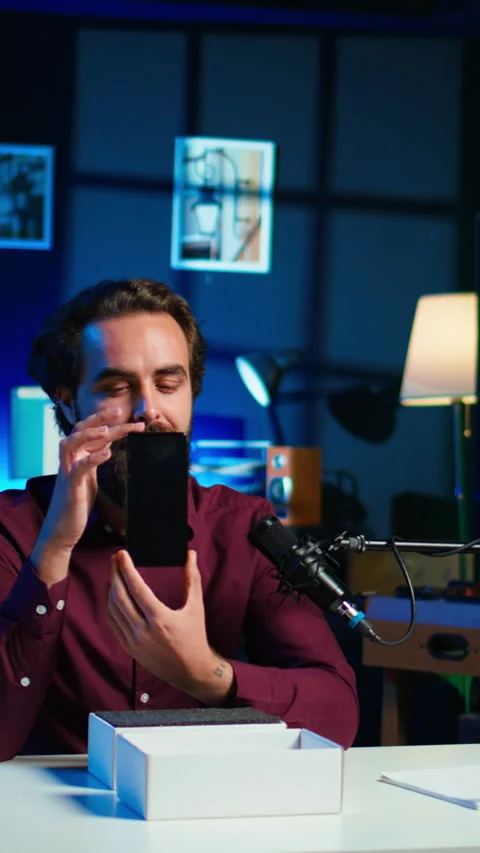 Vertical video Tech guru assessing smartphone performance Stock Footage 306700208