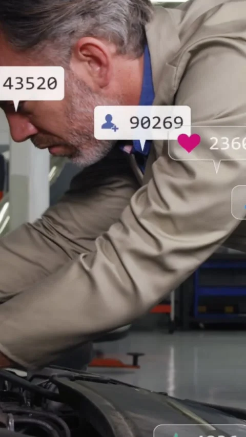Vertical video: Tech inspecting bay, using wrench tightening bolt for auto Stock Footage 334544735
