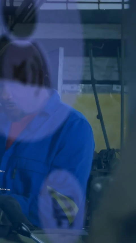 Vertical video: Tech leaning and pulling lever in shop, causing HUD overlay Stock Footage 334541140