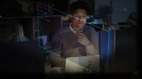 Vertical video: Tech man sitting at desk, analyzing laptop data while screen Stock Footage 334036581