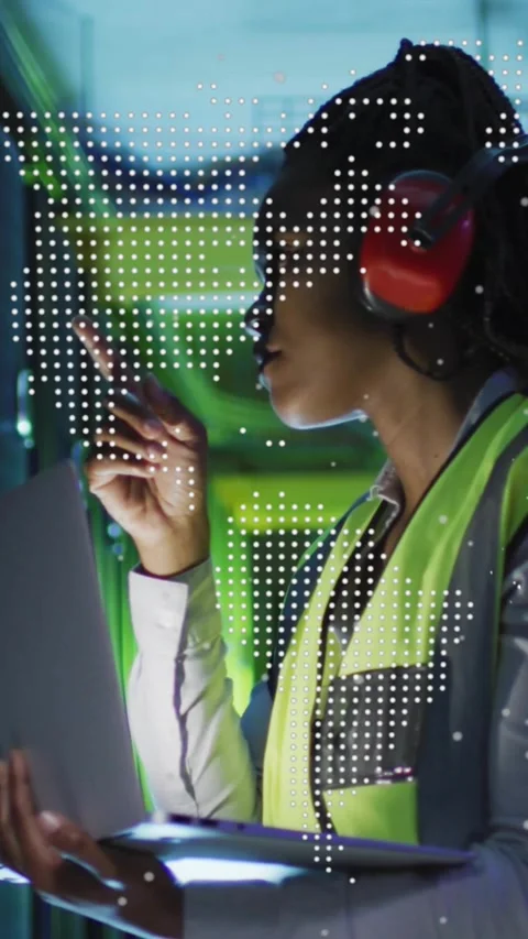 Vertical video: Tech in plant tapping panel while checking data with tablet, Stock Footage 334318945