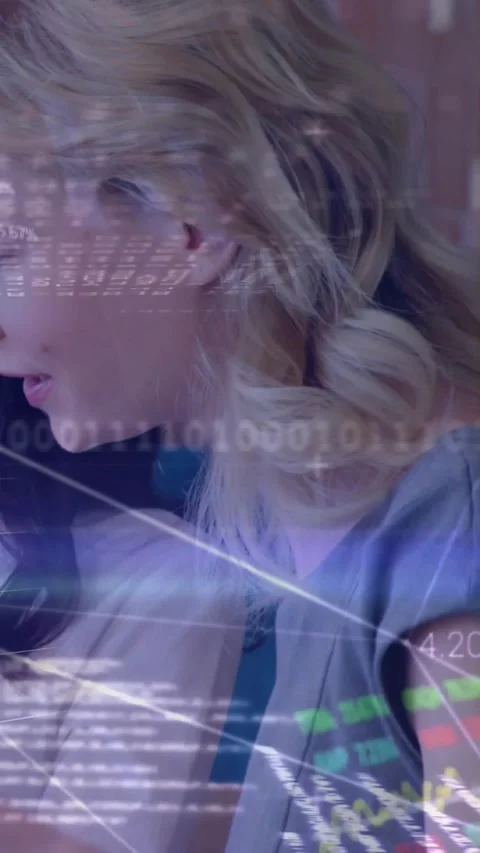 Vertical video: Tech screen updating data, woman leaning to analyze, HUD graphs Stock Footage 331738965