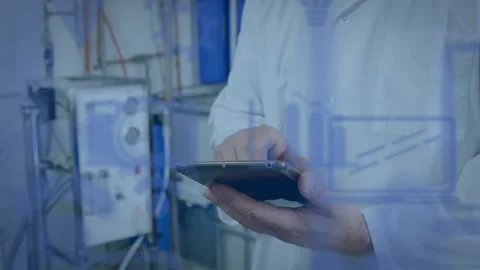 Vertical video: Tech tapping tablet, charts overlaying controls, monitoring as Stock Footage 330793814