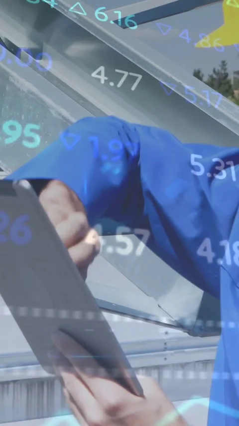 Vertical video: Tech tapping tablet, launching data graphs over him, solar Stock Footage 334605174
