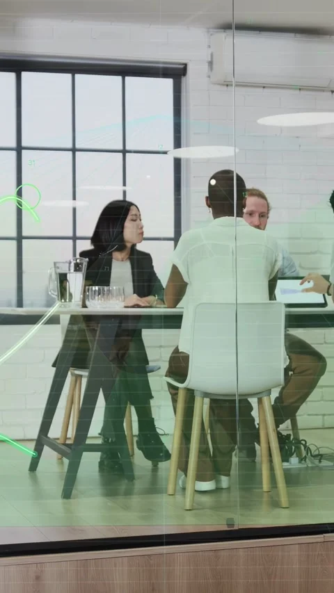 Vertical video: Tech team at glass table, peer tapping tablet making green wave Stock Footage 335513925