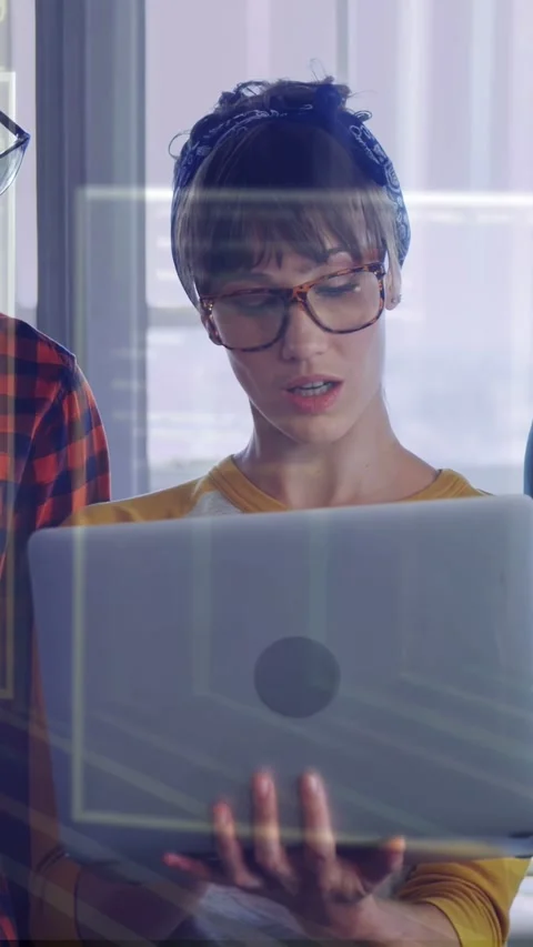Vertical video: Tech woman opening laptop and reviewing code with team, UI Video stock 335355841
