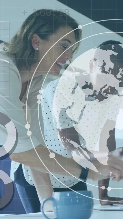 Vertical video: Tech women leaning over desk, tapping tablet, activating globe Stock Footage 340133486