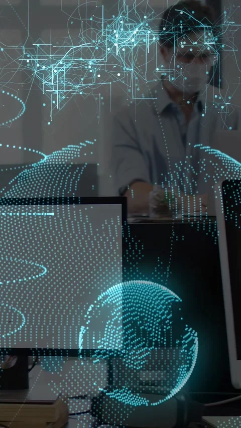 Vertical video: Tech worker leaning on keys and initiating teal globe showing Stock Footage 333109473