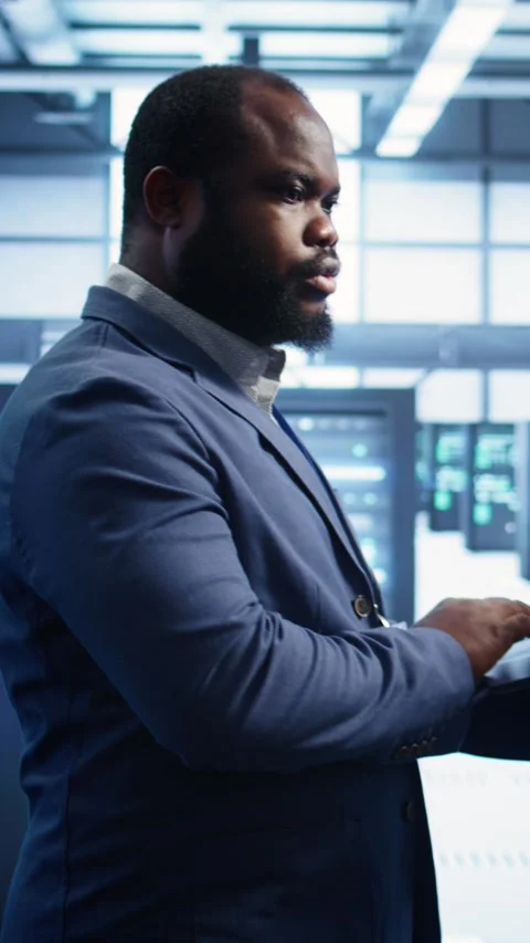 Vertical video Technician in data center running system diagnostic tests Stock Footage 277856793