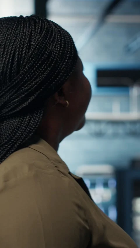 Vertical video Technician in data center overseeing large scale IT gear Stock Footage 316858314