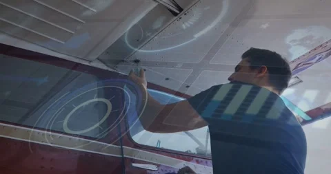 Vertical video: Technician reaching up, turning tool on aircraft seam, Stock Footage 333905006