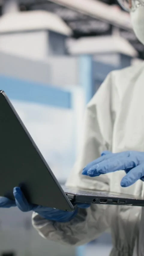 Vertical video Technician in semiconductor production plant facility using Video stock 333615213