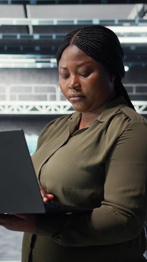 Vertical video Technician in server farm using laptop to upgrade rigs Stock Footage 317055103