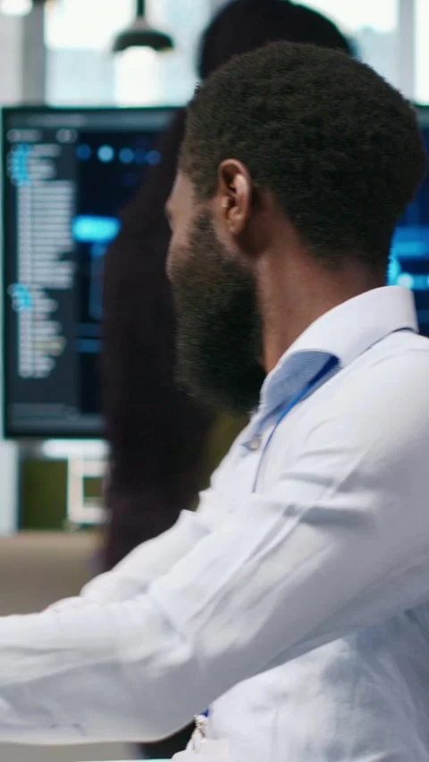 Vertical video Technician using PC to code, testing applications to minimize Stock Footage 312768087