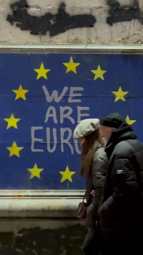 Vertical video. Text We are Europe, EU flag, yellow star on blue house wall Stock Footage 304765881