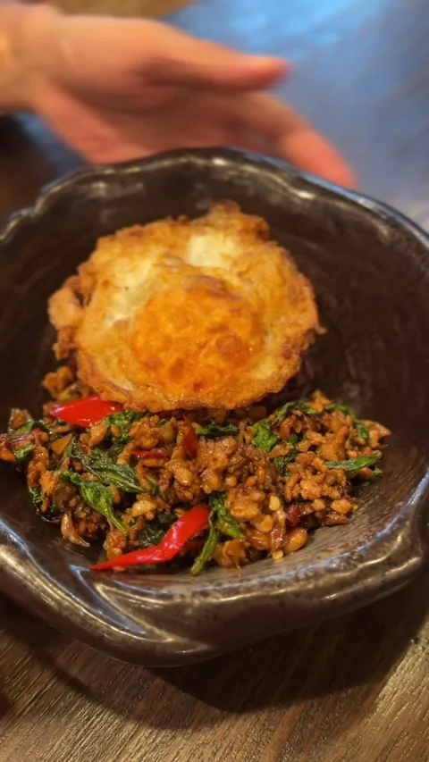 Vertical video of Thai basil pork stir fry with crispy fried egg Stock Footage 322967709