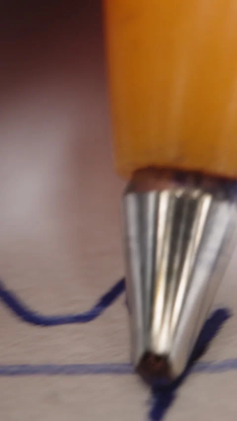Vertical video. They scribble with a pen on paper, the camera closely follows th Video stock 260955805