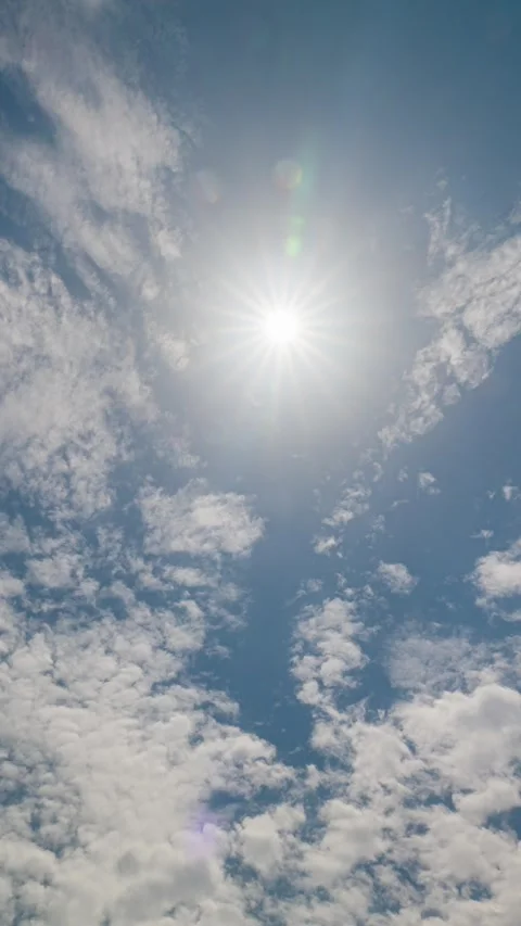 Vertical video, thin white clouds drift across the blazing summer sun. Stock Footage 336037150