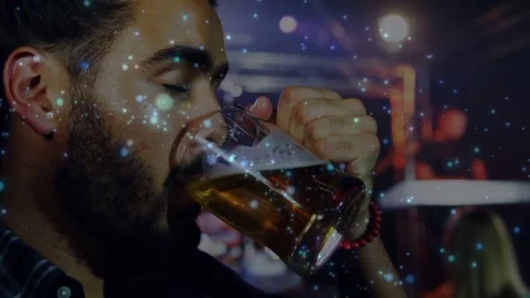 Vertical video: Thirst driving man lifting beer mug and drinking at dim bar, red Stock Footage 331380402