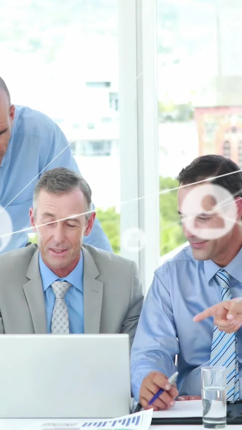 Vertical video: Three business men pointing pen at laptop causing network nodes Stock Footage 334544840