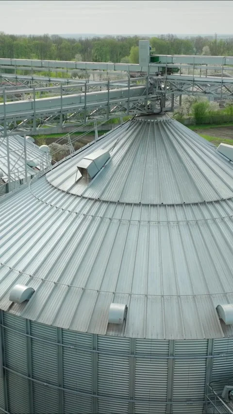 Vertical video. The three large grain silos. The corrugated metal cylinders used Stock Footage 325810727