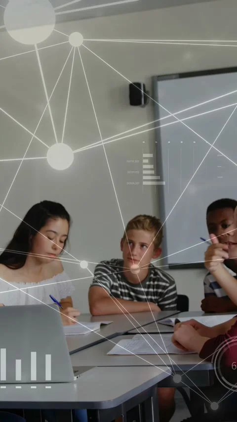 Vertical video: Three students working in school using laptop and notes as AR Stock Footage 334423458