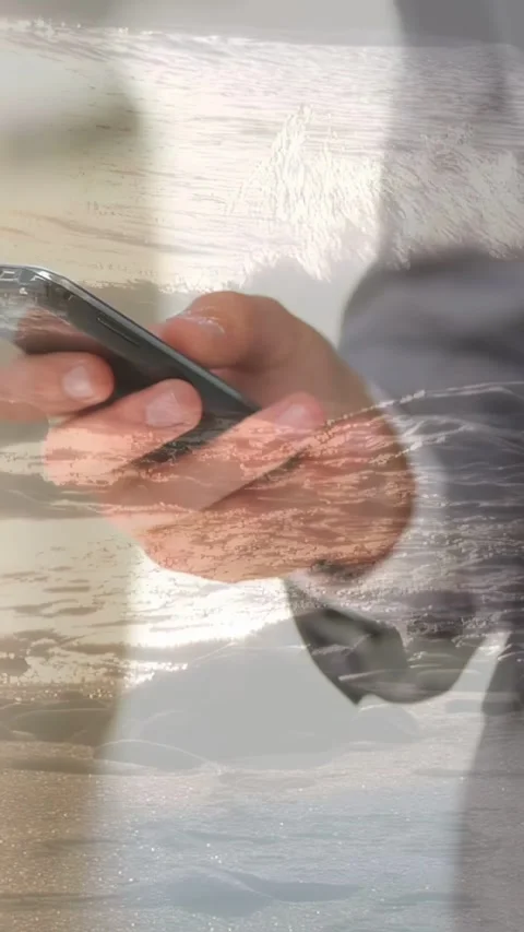 Vertical video: Thumb tap starting hands swiping phone, rotating, sea overlay Stock Footage 333496115