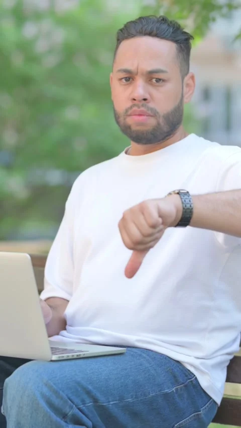 Vertical video, Thumbs Down by Young Man Using Laptop Outdoor Vídeos de archivo 320238650