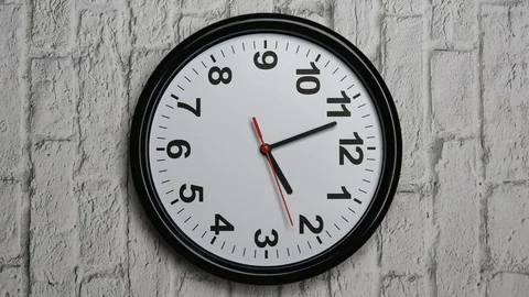Vertical video. The Time On The Clock Two. Clock With The Black Arrows And Red S 스톡 동영상 128551154