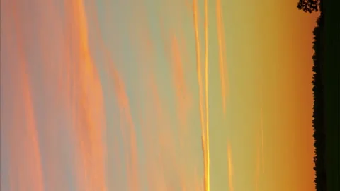 Vertical video Time laps sky in the reflections of the sunset with running Stock Footage 157783132