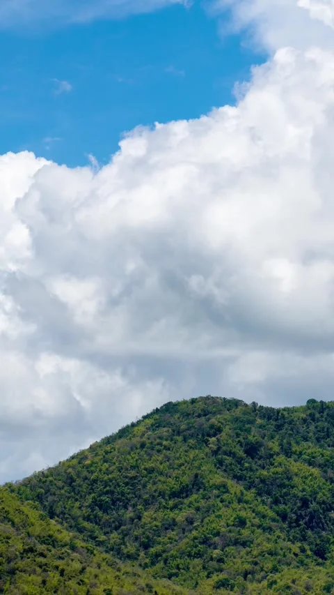 Vertical video time lapse of white clouds and blue sky with mountains. Stock Footage 310034556