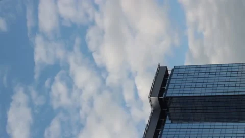 Vertical video, timelapse, white clouds fly above a tall building Stock Footage 131951382
