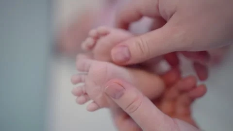 Vertical video of tiny Feet in Parent's Hands in 4k slow motion 60fps Stock Footage 263917376