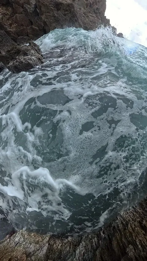 Vertical video. Tiny Planet. A close-up slow-motion shot of ocean waves 스톡 동영상 293683214