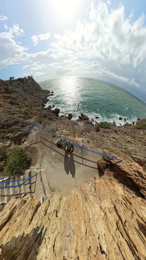 Vertical video. "Tiny planet" effect showing a man and woman at the edge of a Video stock 294796921