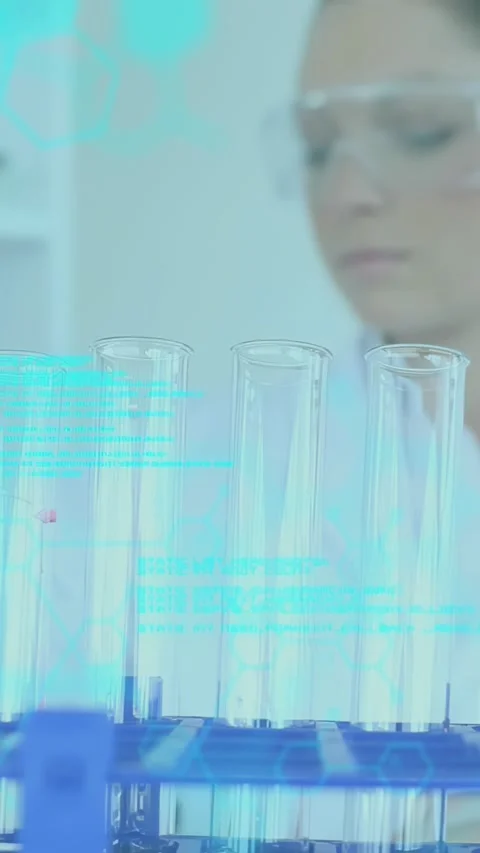 Vertical video: Tip entry causing lab tech adding red drop into tube for test, Video stock 330359178