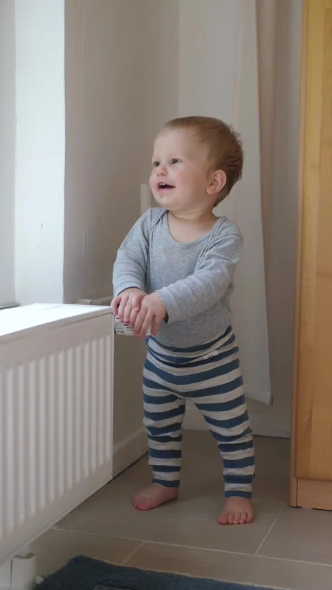 Vertical video Toddler Radiator Stock Footage 289746301