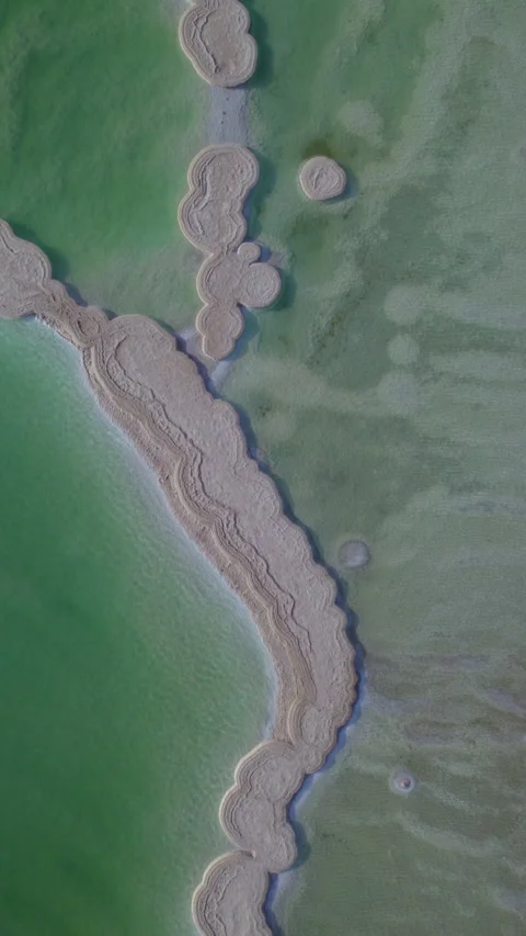 Vertical video top down view of huge lumps of salt created by the movement of Stock Footage 315627169