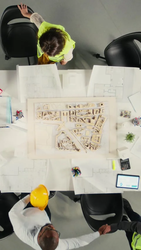 Vertical Video Top down view of development team consulting on real estate Stock Footage 319806711