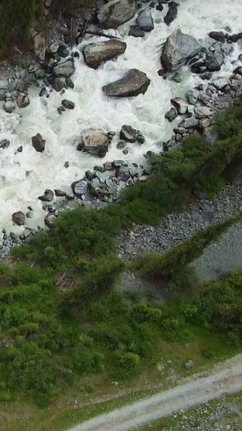 Vertical video: Top Down View of SUV on S-Curve Mountain Road Video stock 332216865