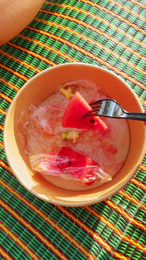 Vertical video. Top Down View Of Bowl With Watermelon Pieces And Plastic Wrap On Stock Footage 332300553