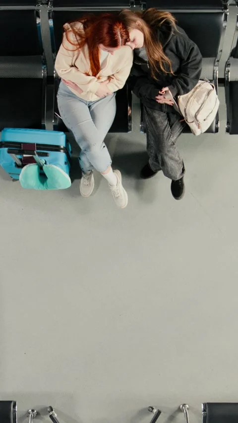 Vertical video Top down view of people waiting in airport, checking flight Stock Footage 334850893
